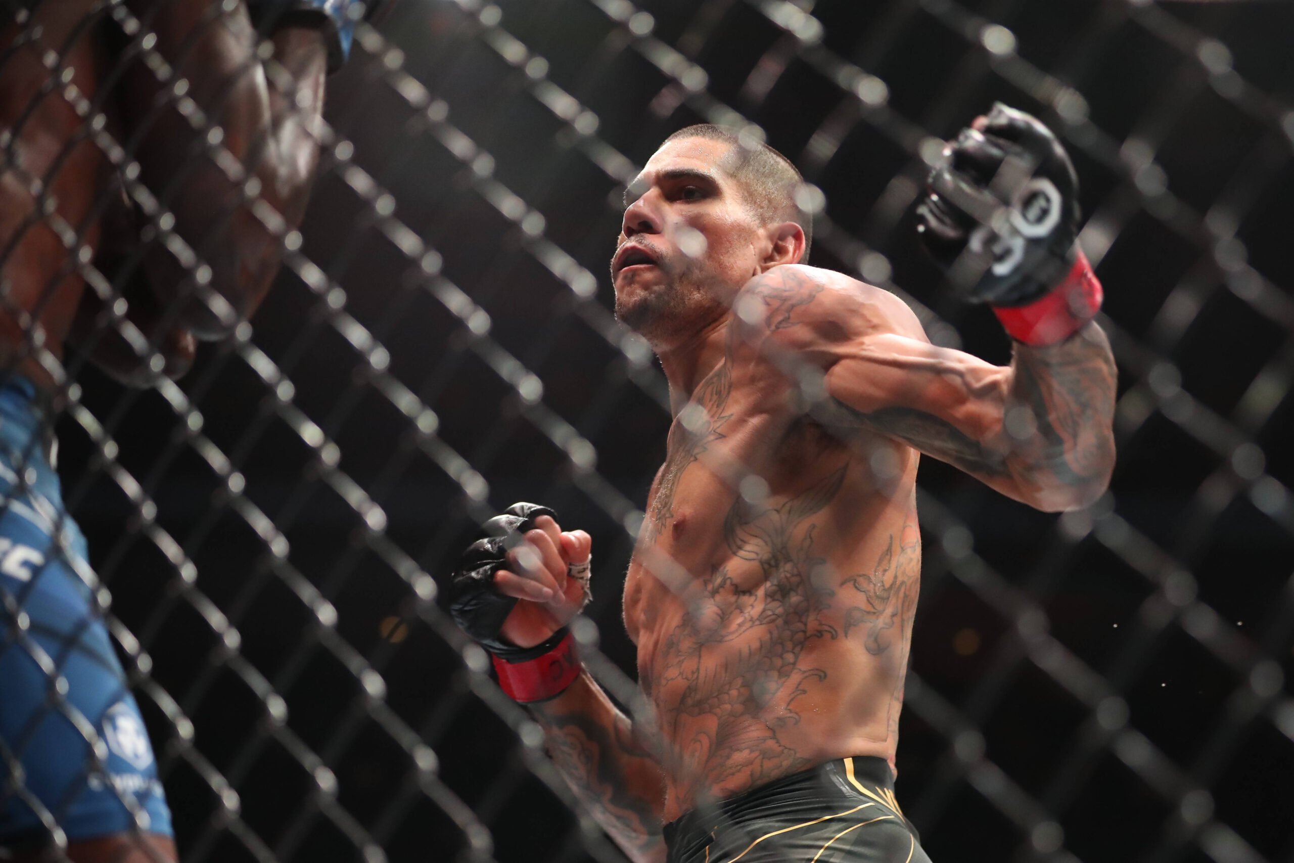 Alex Pereira throws a pair of hooks at Israel Adesanya.