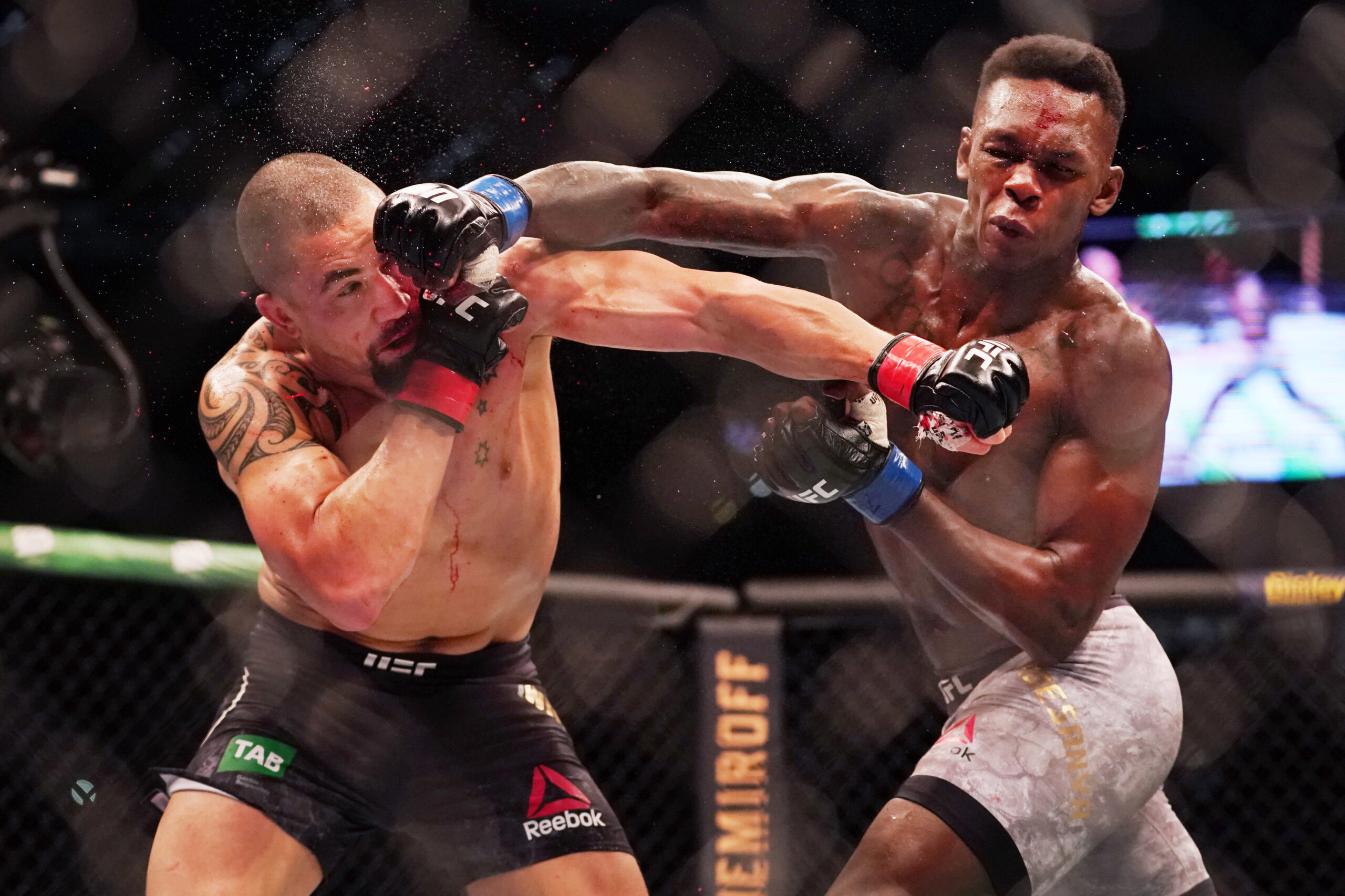 Israel Adesanya punches Robert Whittaker at UFC 243 in 2019.