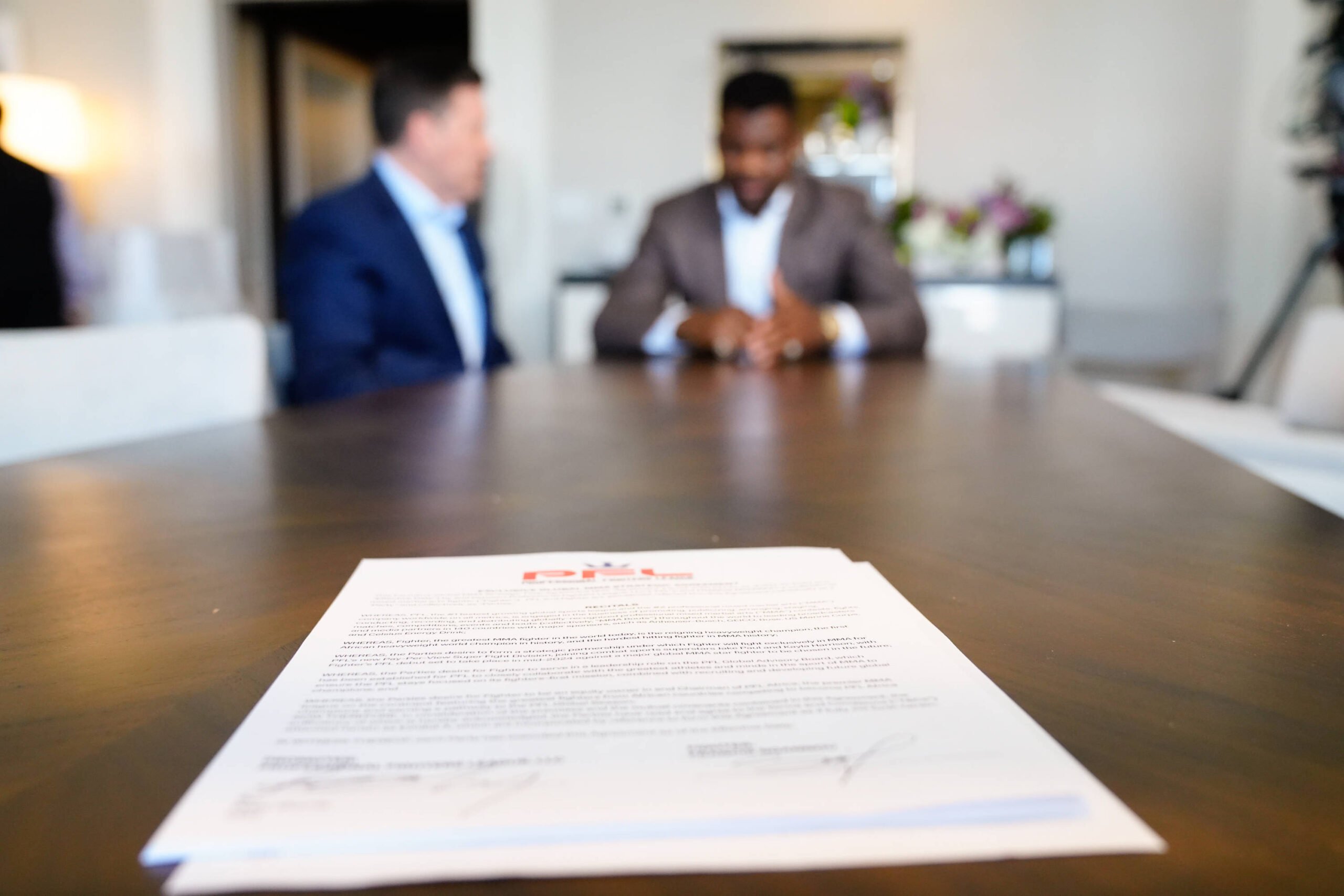 Francis Ngannou and Peter Murray, CEO of PFL sign a deal.