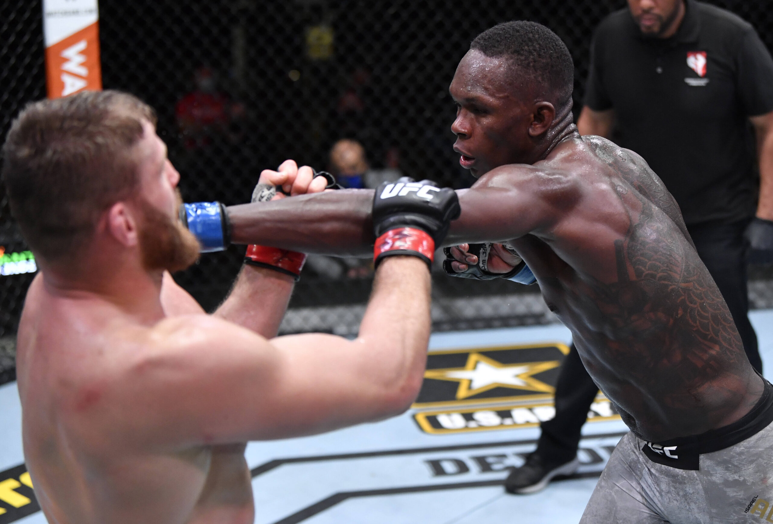 Israel Adesanya punches Jan Blachowicz at UFC 259.