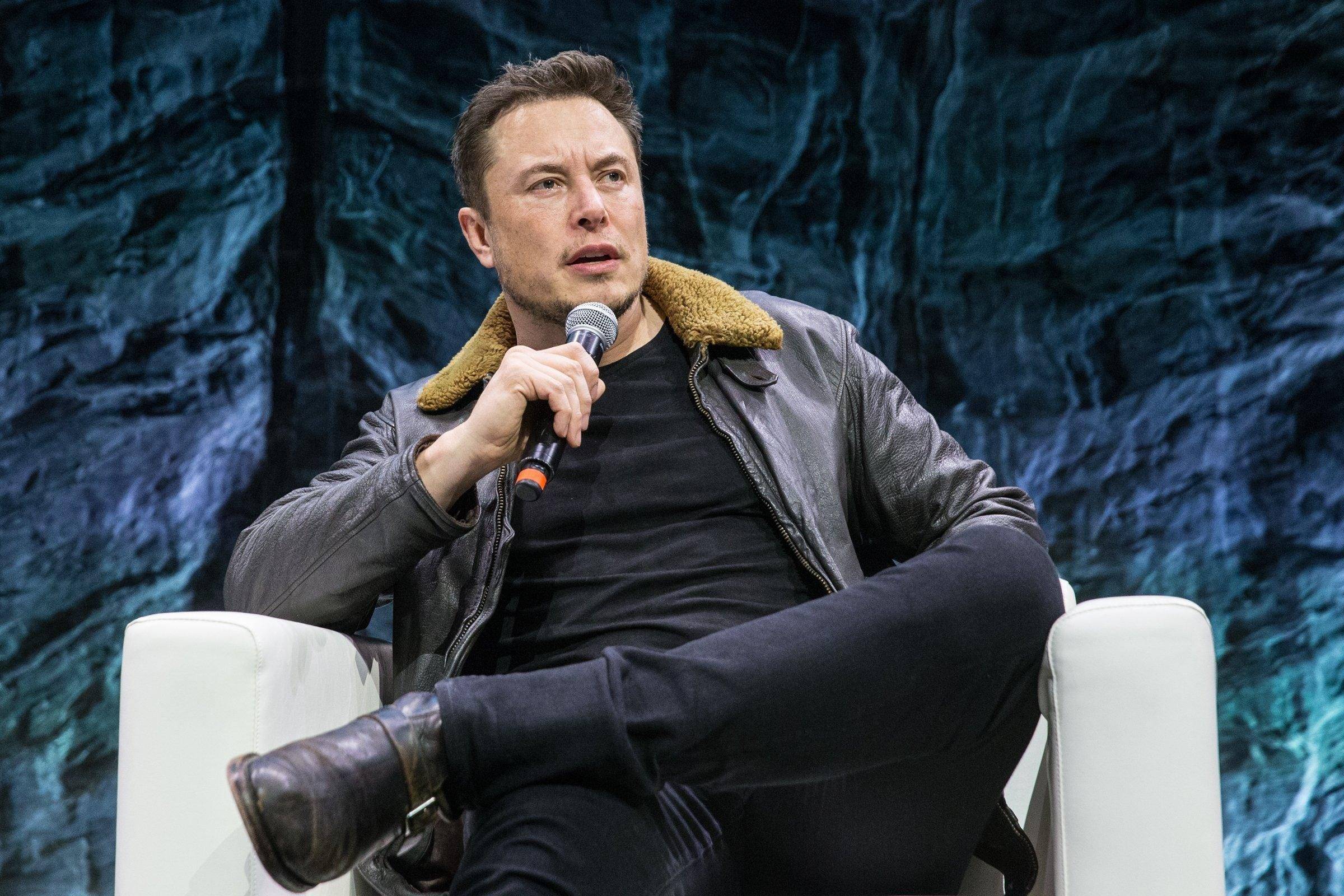 Elon Musk at a 2018 SpaceX presentation. Dana White.