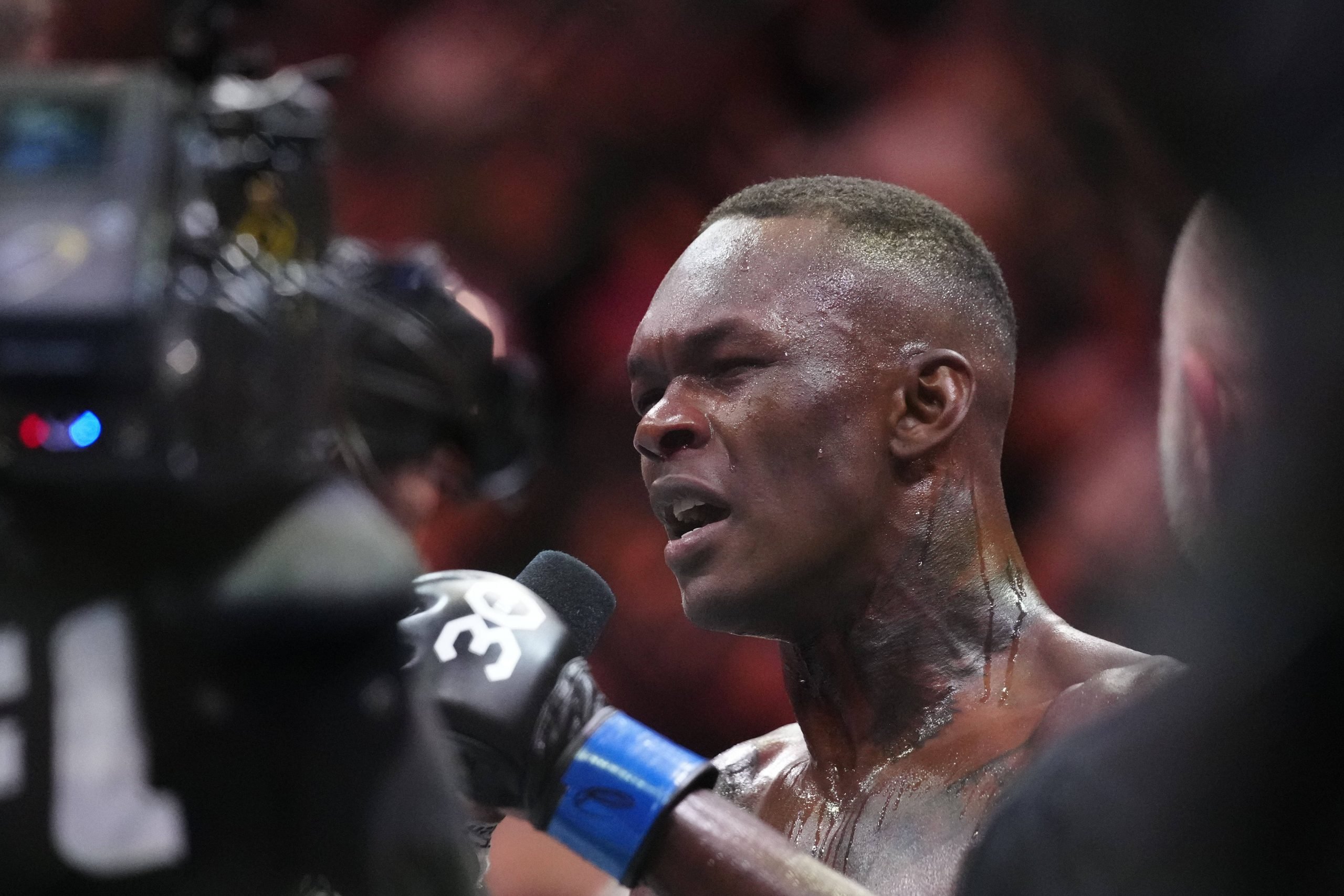 Miami, Florida, USA; Israel Adesanya (blue gloves) reacts to defeating Alex Pereira (red gloves) during UFC 287 at Miami-Dade Arena. Miami Miami-Da...