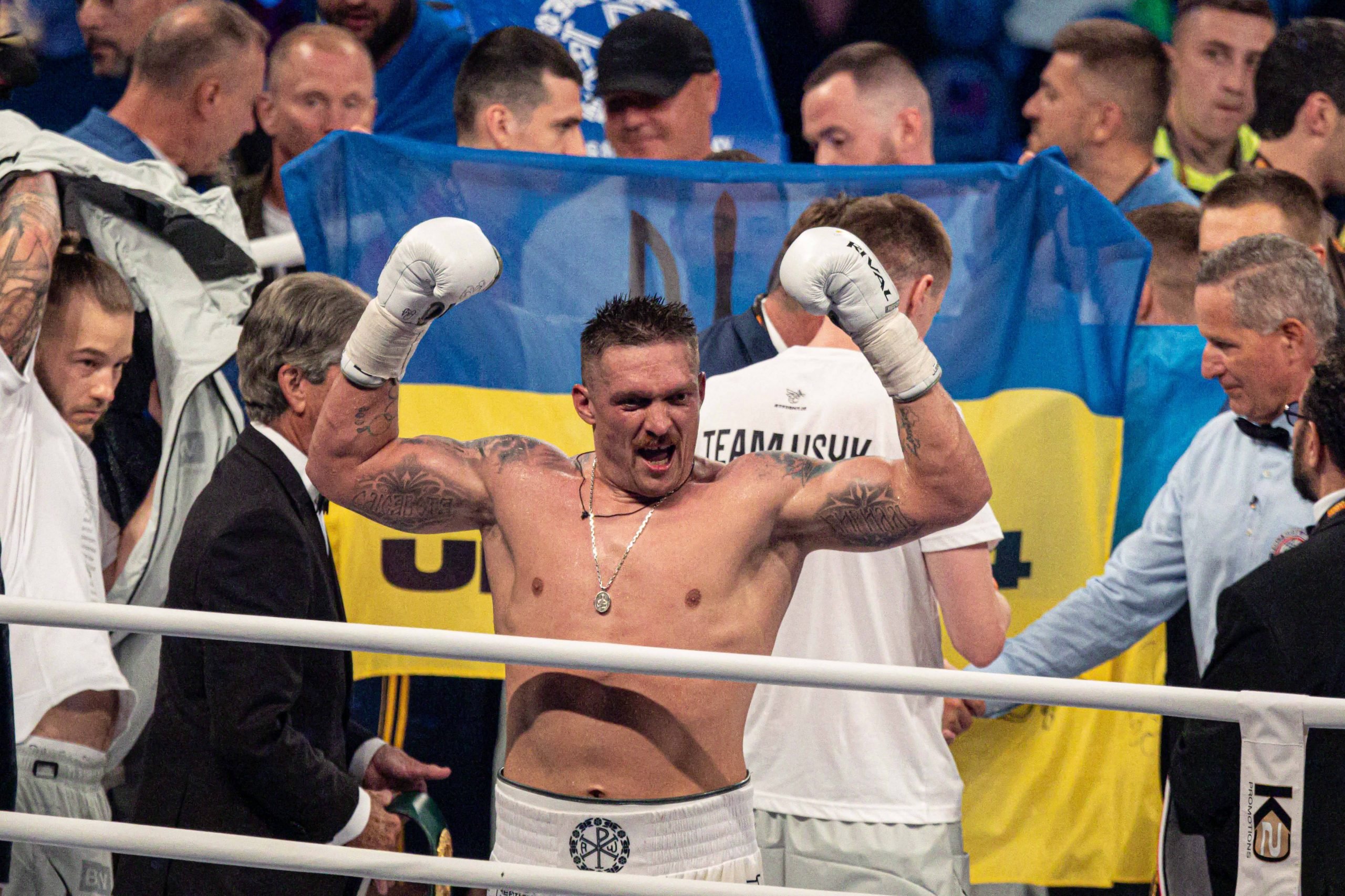 Oleksandr Usyk celebrates after his victory over Daniel Dubois in Poland