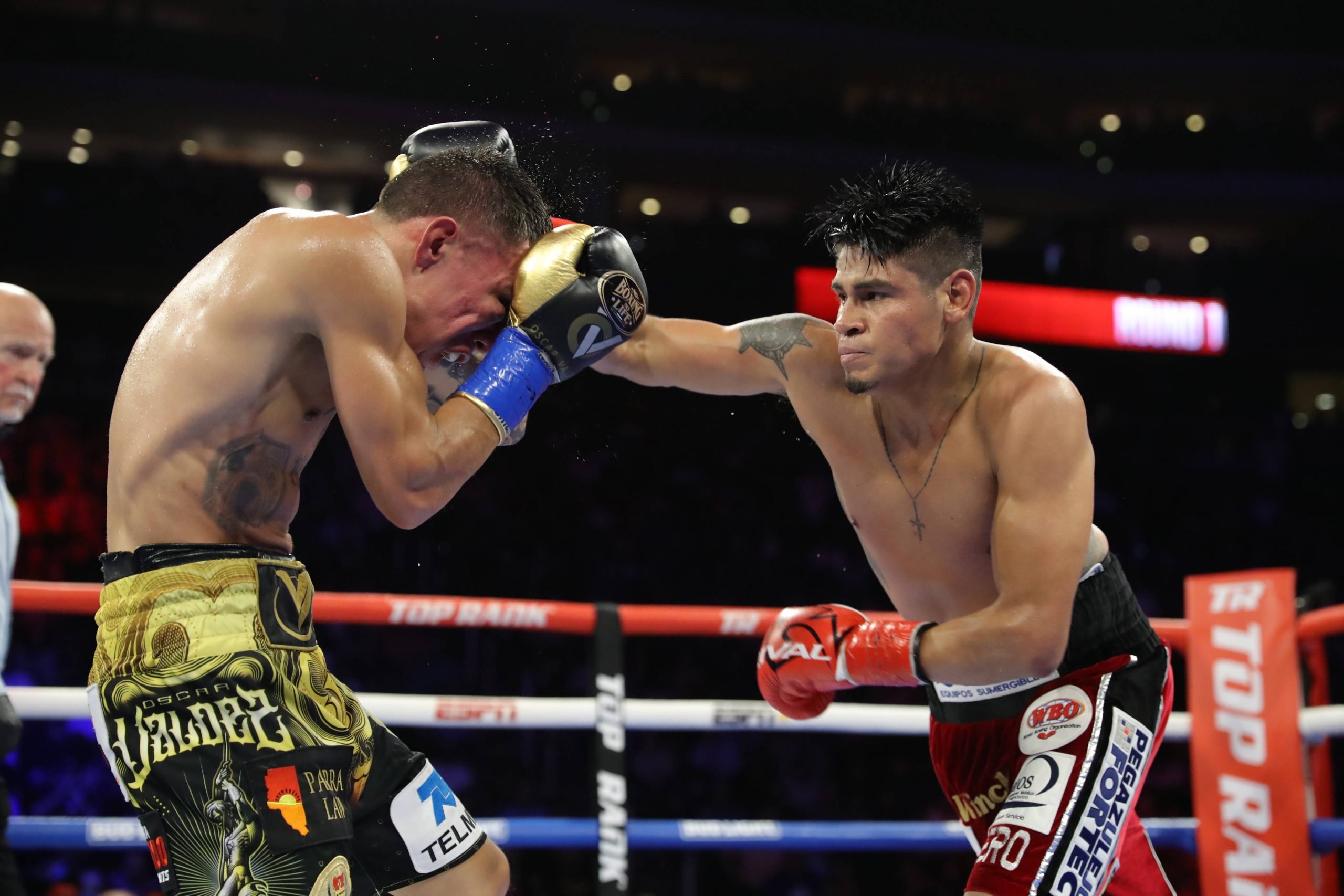 Emanuel Navarrete lands on Oscar Valdez during their title showdown