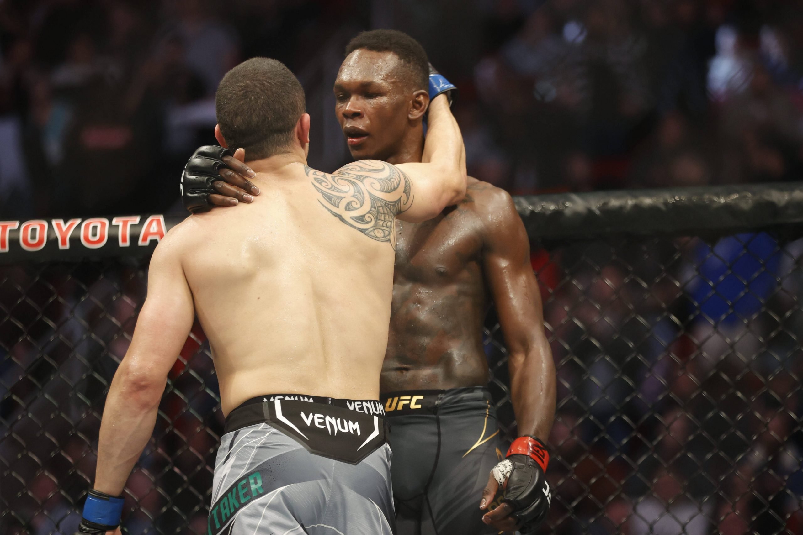 MMA: UFC 271-Adesanya vs Whittaker, Feb 12, 2022; Houston, Texas, UNITED STATES; Israel Adesanya (red gloves) and Robert Whittaker (blue gloves) re...