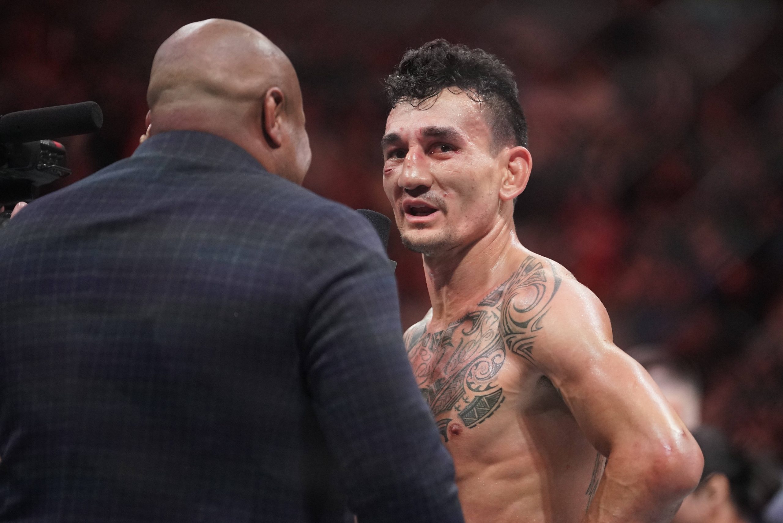 Max Holloway (red gloves) reacts after the fight against Arnold Allen (blue gloves) during UFC Fight Night at T-Mobile Center. Kansas City T-Mobile...