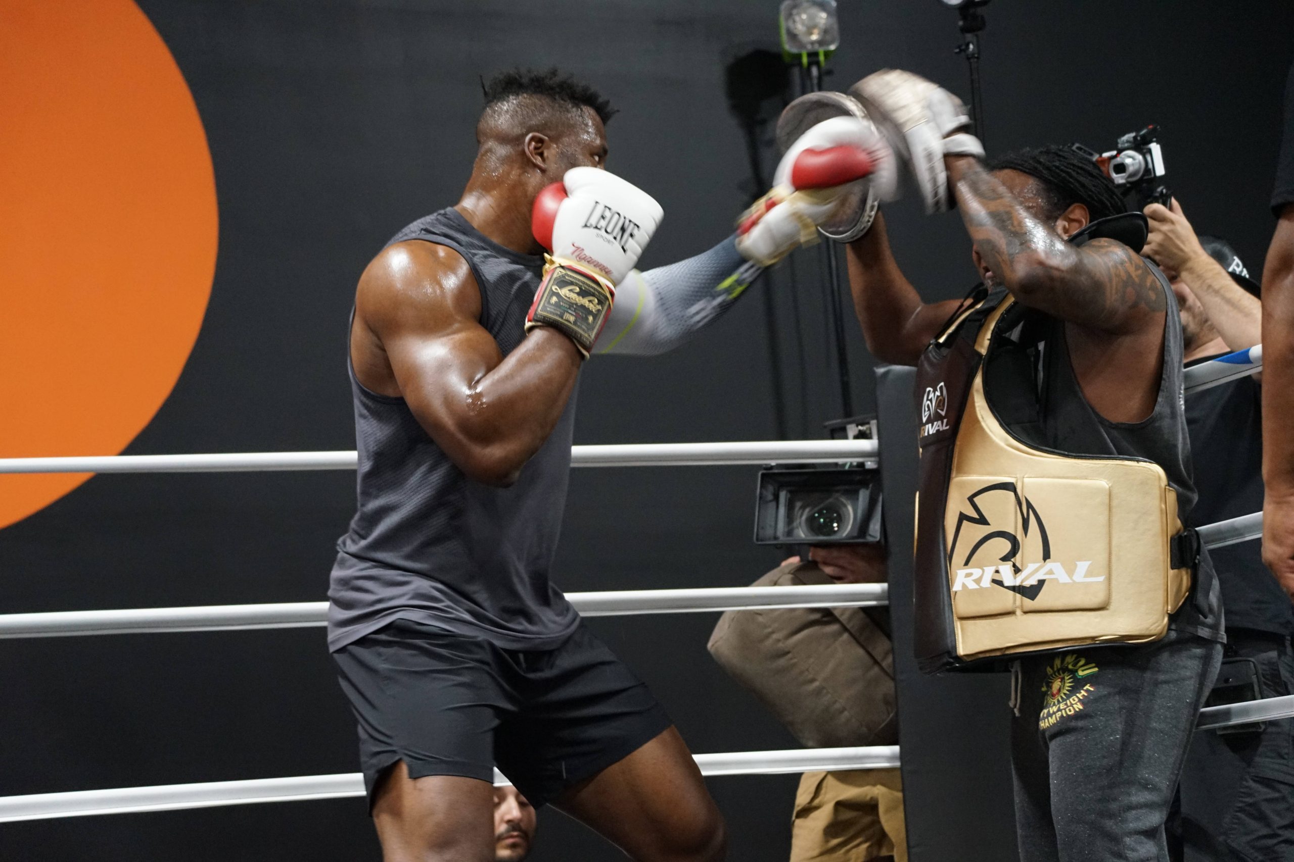 Francis Ngannou spars with coach Dewey Cooper.
