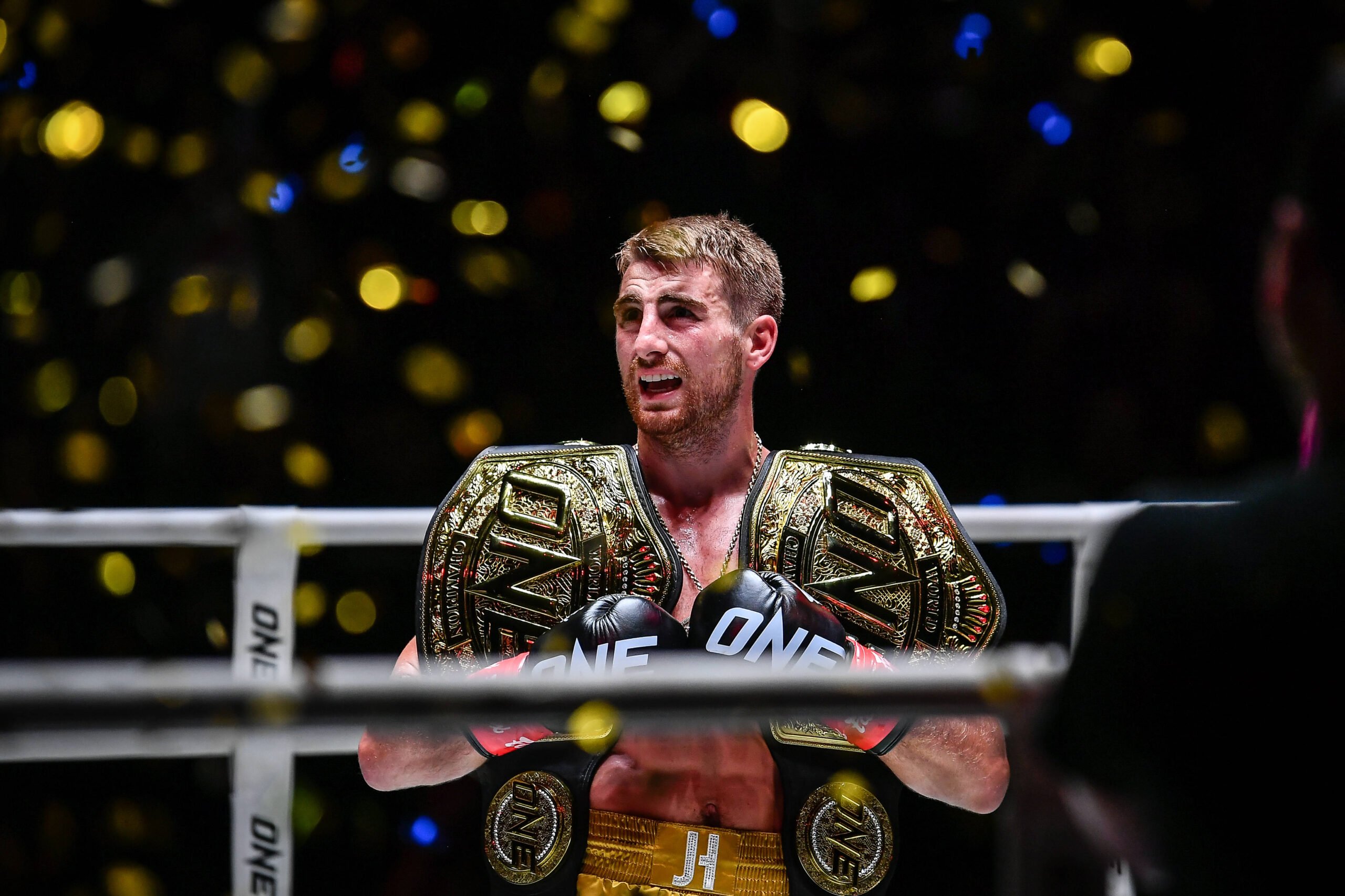 Jonathan Haggerty of England seen carrying kickboxing belts during the match of ONE Fight Night 16 at Lumpinee Boxing Stadium. Bangkok Thailand