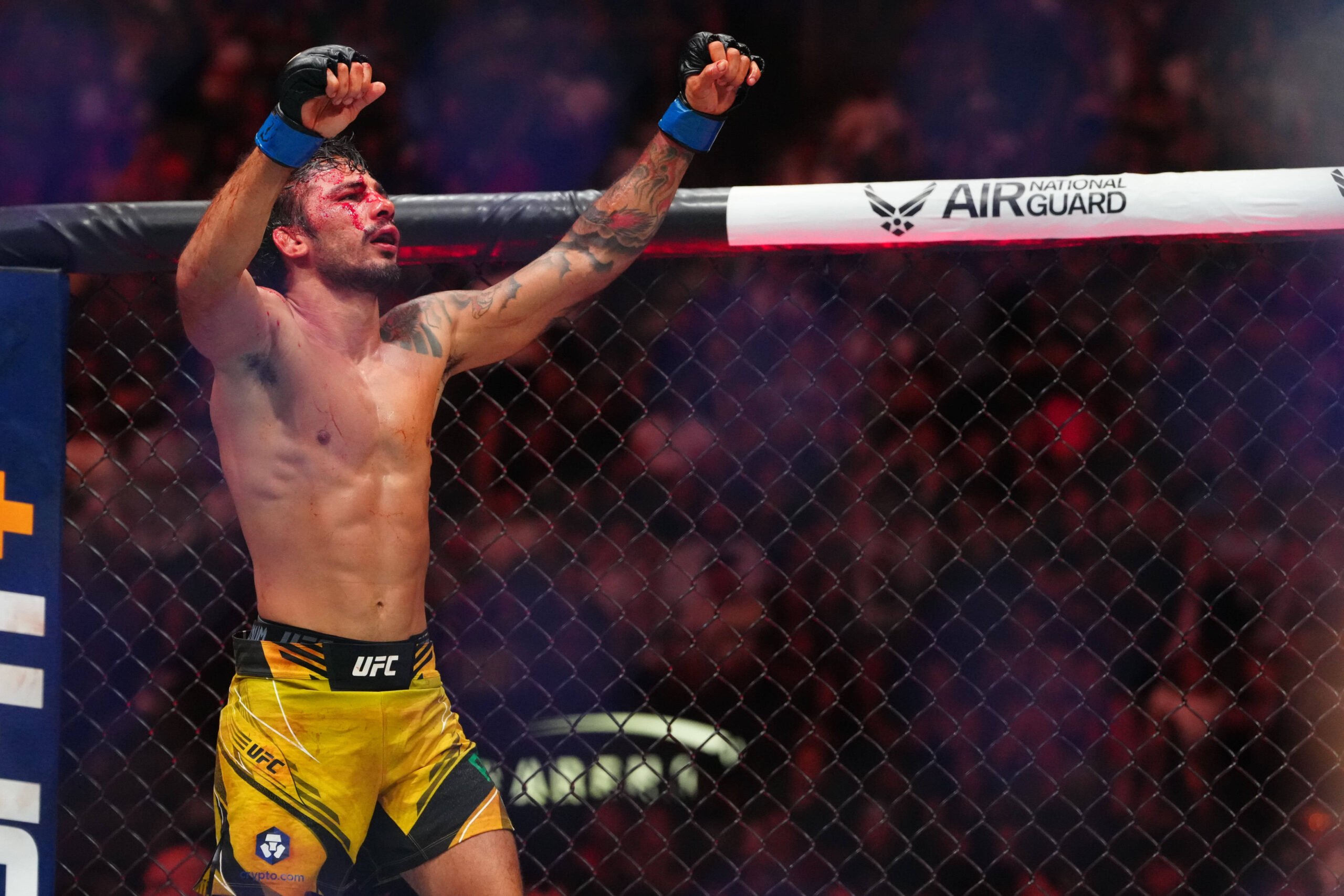 UFC 296's Alexandre Pantoja (blue gloves) reacts to defeating Brandon Moreno (red gloves) during UFC 290 at T-Mobile Arena.