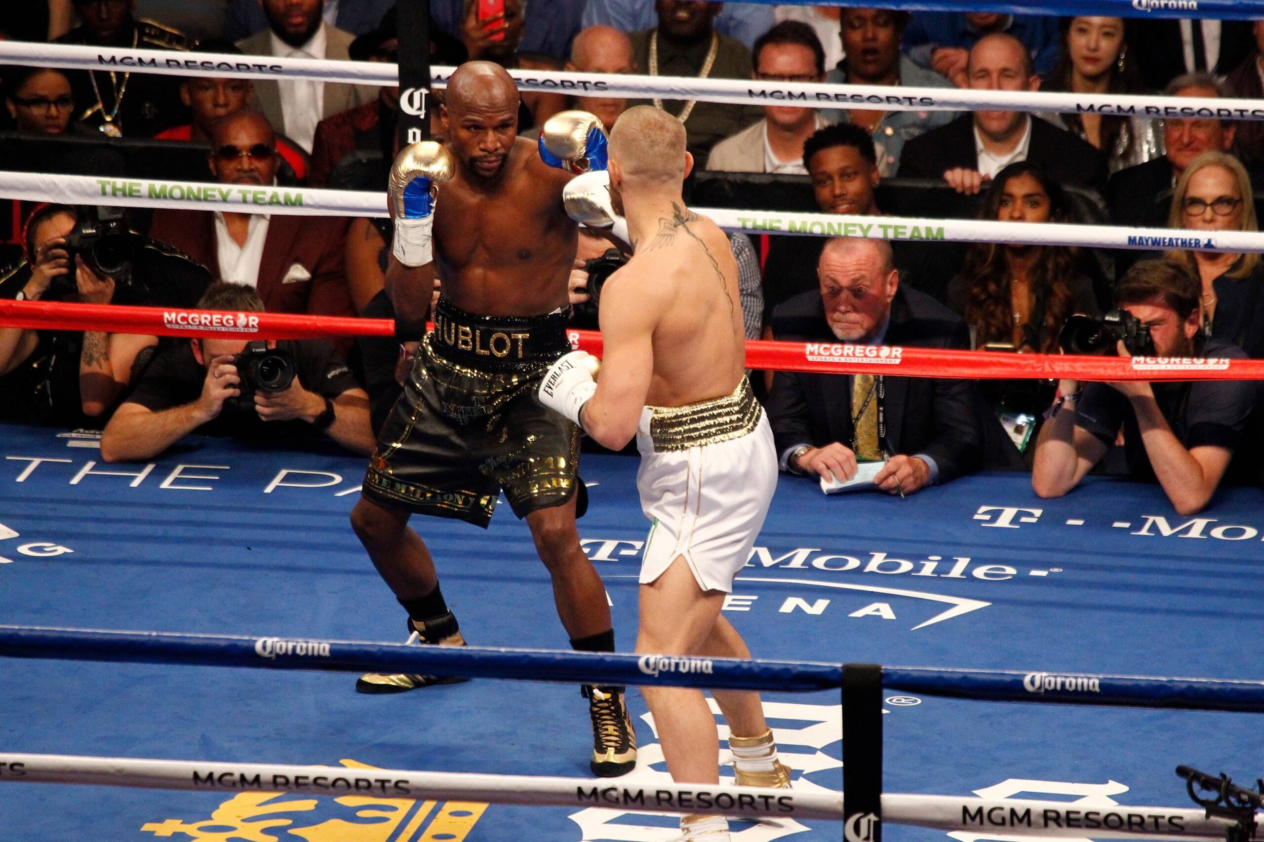 Floyd Mayweather Jr. (L) and Conor McGregor during the first round of their super-welterweight bout at T-Mobile Arena in Las Vegas, Nevada on Augus...