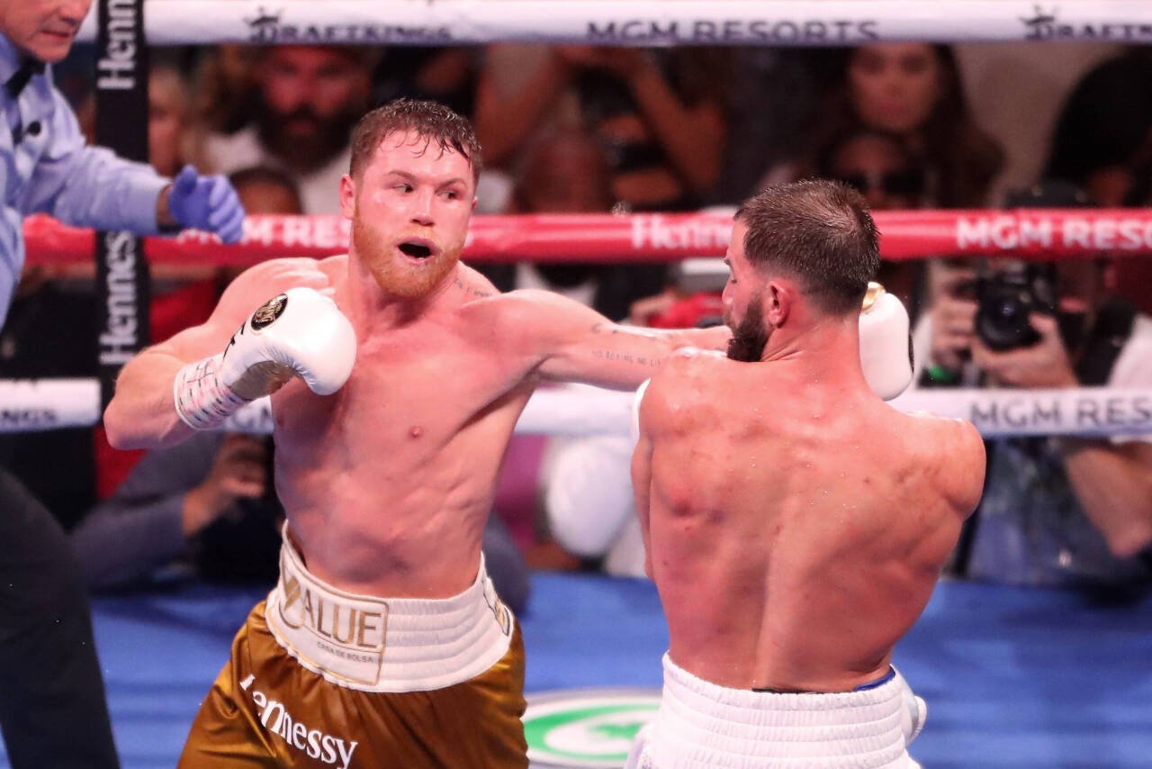 LAS VEGAS, NV - NOVEMBER 6: (L-R) Canelo Alvarez punches Caleb Plant during their WBA WBC WBO super-middleweight 168-pound title fight on November ...
