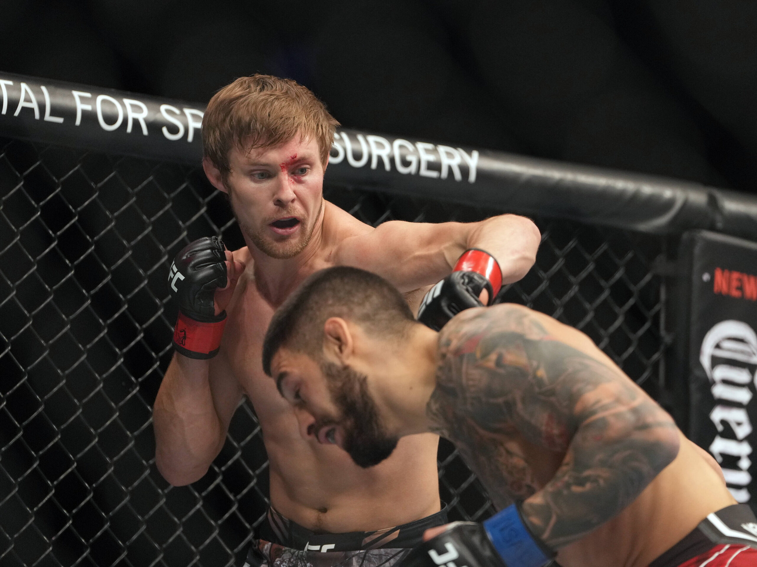 MMA: UFC 282 - Mitchell vs Topuria Dec 10, 2022; Las Vegas, Nevada, USA; Bryce Mitchell (red gloves) fights Ilia Topuria (blue gloves) during UFC 2...