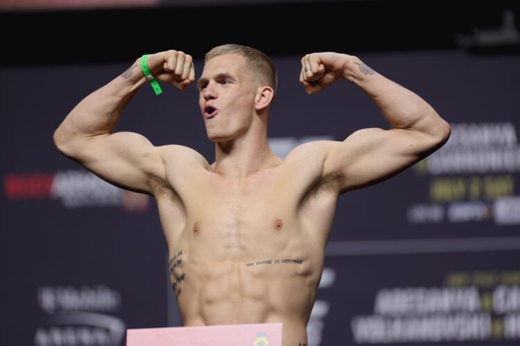 Ian Garry of Ireland poses on the scale during the UFC 276 ceremonial weigh-in at T-Mobile Arena on July 01, 2022 in Las Vegas, Nevada.