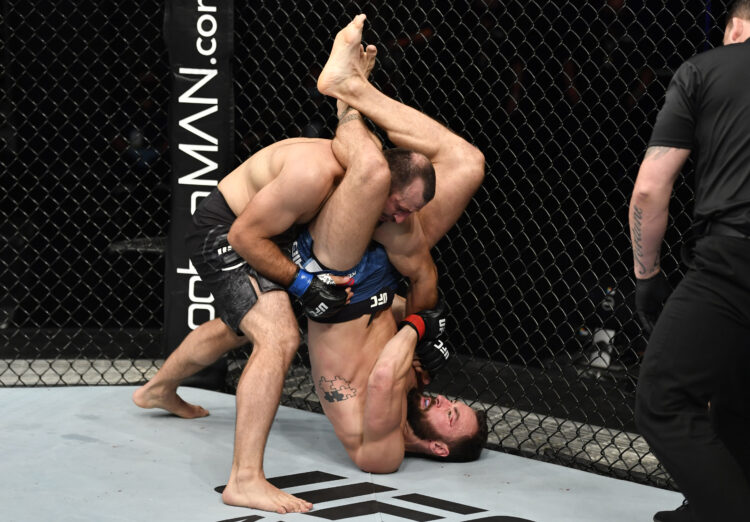 In this handout image provided by UFC, (R-L) Paul Craig of Scotland attempts to secure a triangle choke against Gadzhimurad Antigulov of Russia in ...