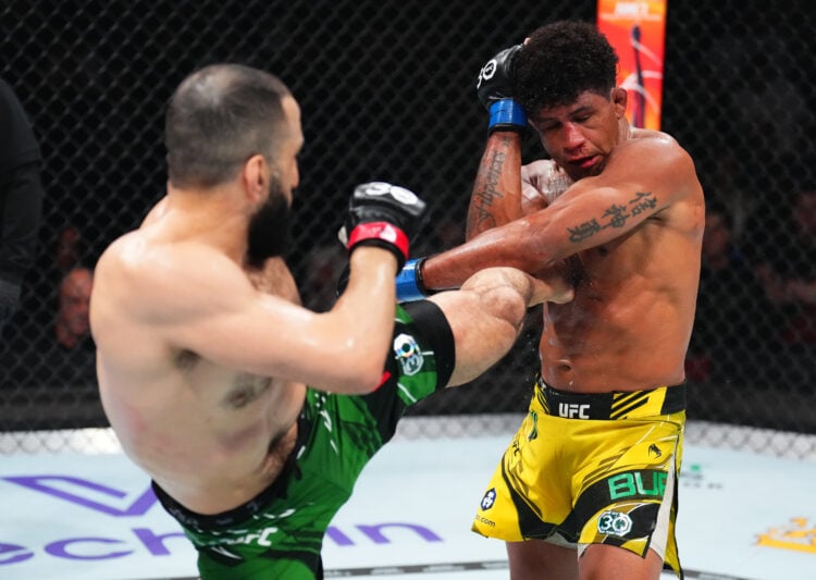 (L-R) Belal Muhammad kicks Gilbert Burns of Brazil in a welterweight fight during the UFC 288 event at Prudential Center on May 06, 2023 in Newark,...