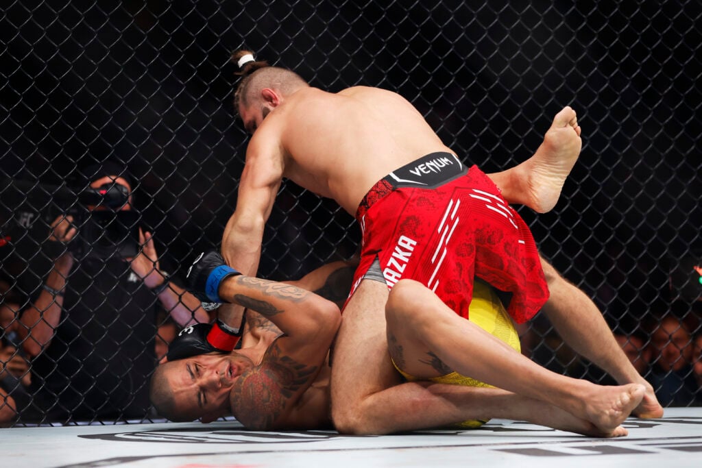 Alex Pereira of Brazil grapples with Jiri Prochazka of the Czech Republic in the UFC light heavyweight championship fight during the UFC 295 event ...