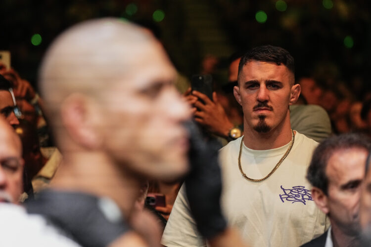 Tom Aspinall looks on as Alex Pereira of Brazil exits the Octagon in the UFC light heavyweight championship fight during the UFC 300 event at T-Mob...