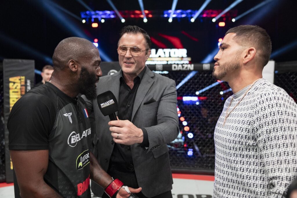 Cedric Doumbe speaks into a Bellator branded microphone held by Chael Sonnen during a faceoff with Anthony Pettis