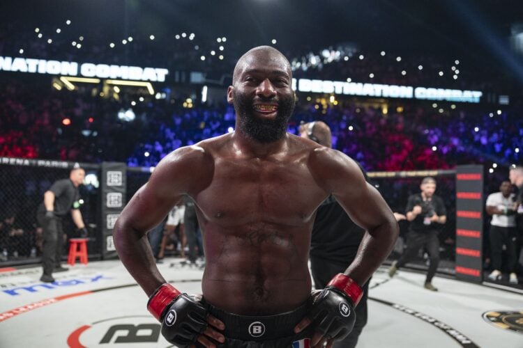 Cedric Doumbe in Bellator gear with hands on hips celebrates his win over Jaleel Willis