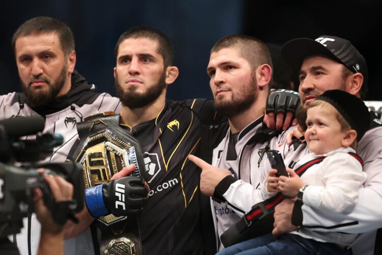 Islam Makhachev (2nd-L) poses for a picture with his coach Khabib Nurmagomedov (2nd-R) and Russian social media star Hasbulla Magomedov (R) after d...