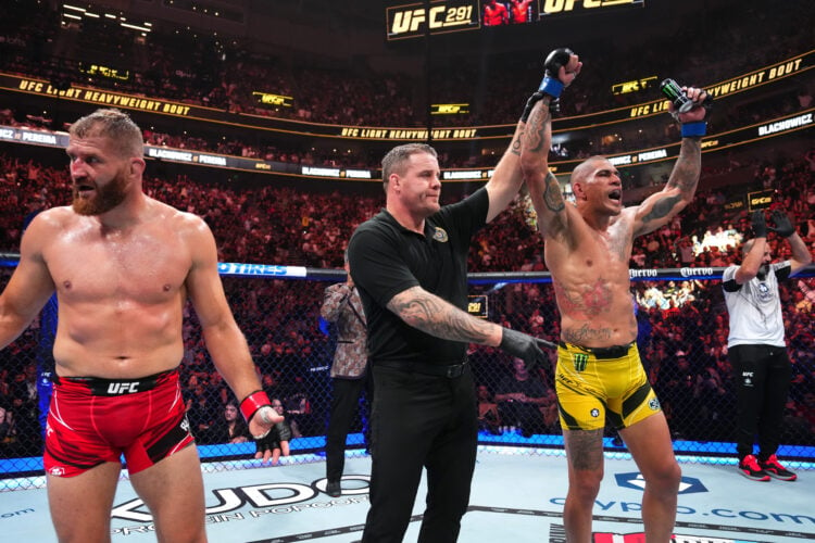 (R-L) Alex Pereira of Brazil celebrates his victory over Jan Blachowicz of Poland in a light heavyweight fight during the UFC 291 event at Delta Ce...