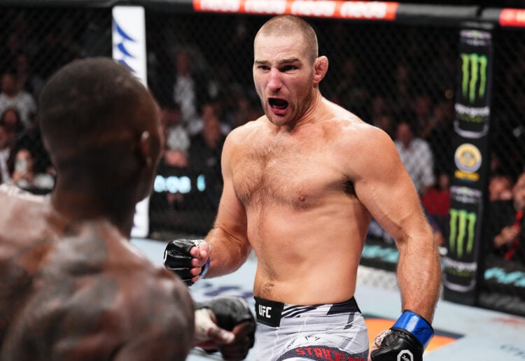 Sean Strickland taunts Israel Adesanya of Nigeria in the closing moments of their UFC middleweight championship fight during the UFC 293 event at Q...