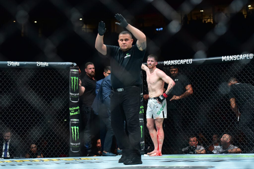 The referee stops the fight after a doctor examines a cut on the shin of Jack Shore during a featherweight bout against Joanderson Brito during the...