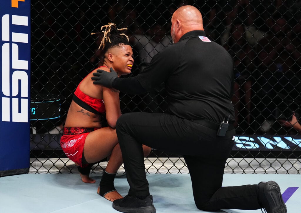Tamires Vidal speaks to Chris Tognoni after a punch to the chest from opponent Melissa Gatto during a UFC fight