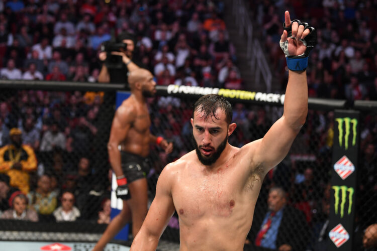 (R-L) Dominick Reyes and Jon Jones walk back to their corners after the first round of their light heavyweight championship bout during the UFC 247...