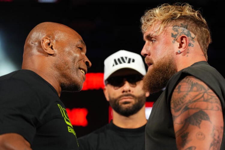 (L-R) Mike Tyson, Nakisa Bidarian and Jake Paul pose onstage during the Jake Paul vs. Mike Tyson Boxing match Arlington press conference at Texas L...