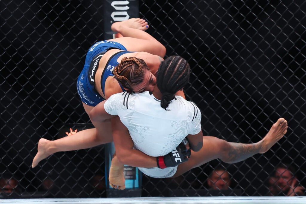 Ailin Perez of Argentina and Joselyne Edwards of Panama grapple in their bantamweight bout during UFC 302