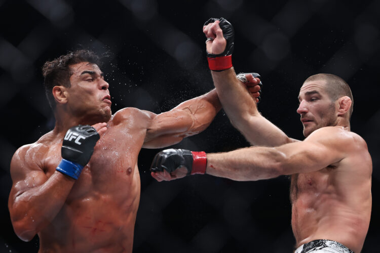 (L-R) Paulo Costa of Brazil and Sean Strickland exchange strikes during UFC 302 at Prudential Center on June 01, 2024 in Newark, New Jersey.