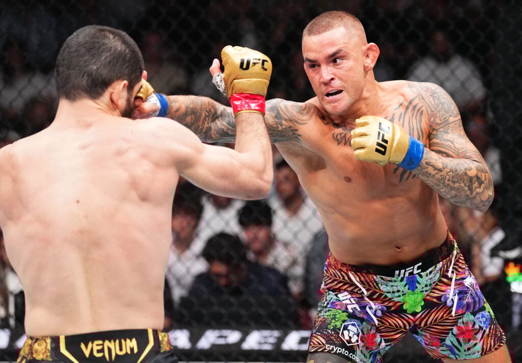 Dustin Poirier punches Islam Makhachev during their UFC 302 fight