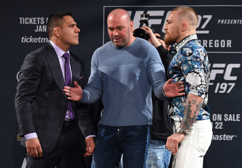 Rafael Dos Anjos and Conor McGregor separated by Dana White at a 2016 press conference