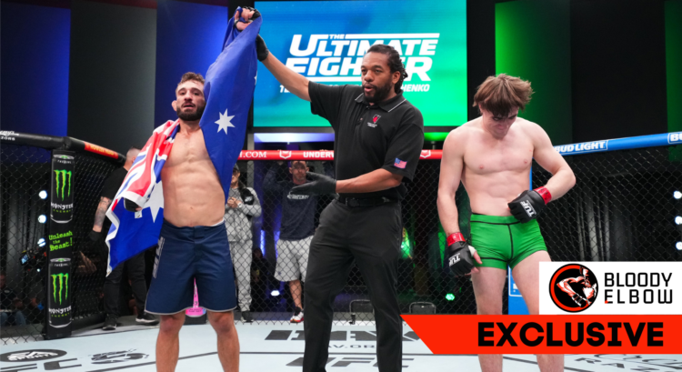 Kaan Ofli with an Australian flag draped around him is declared the winner by referee Herb Dean against Nathan Fletcher in green shorts