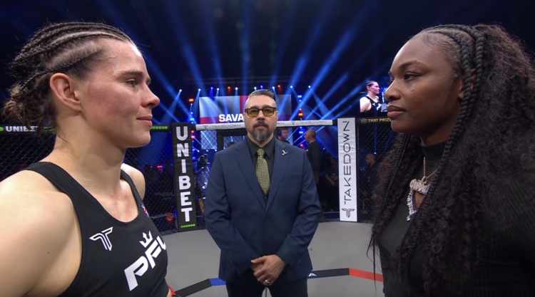 Savannah Marshall and Claressa Shields facing off, with Dan Hardy in a suit standing between them