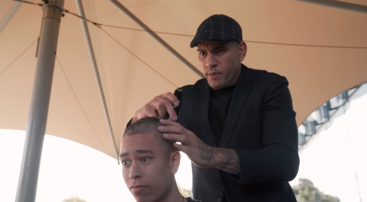 Alex Pereira shaves a fan's head