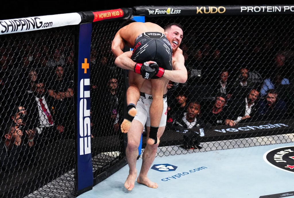 Merab Dvalishvili carries Henry Cejudo over his shoulder during UFC 298 fight