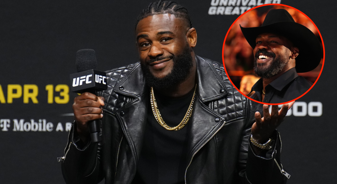 Aljamain Sterling (left) at the UFC 298 ceremonial weigh-ins with a pop out image of Jon Jones (right)