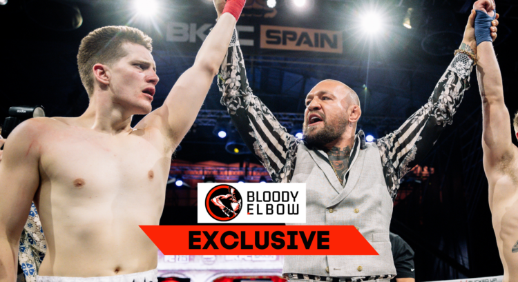 Ben Davis (l) has his hand raised by Conor McGregor (r). Overlay text reads: BLOODY ELBOW EXCLUSIVE