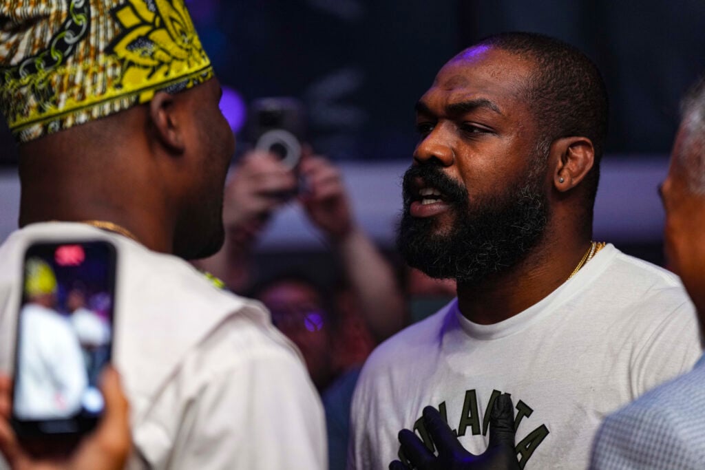 Jon Jones and Francis Ngannou face off cageside at a PFL event in 2023