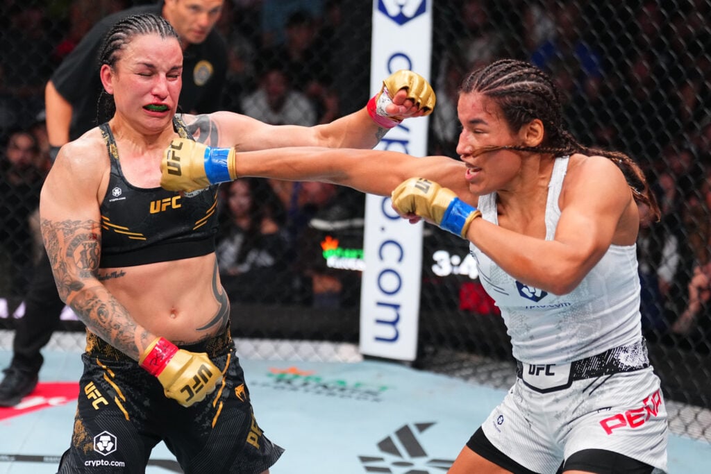 Julianna Pena punches Raquel Pennington during their UFC 307 fight