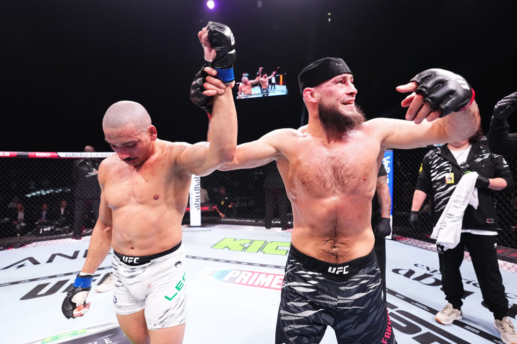 Rinat Fakhretdinov raises the arm of Carlos Leal after their UFC 308 fight