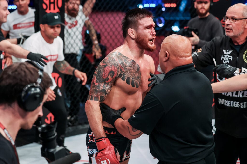 Johnny Eblen being held back by security after his win at Bellator 299