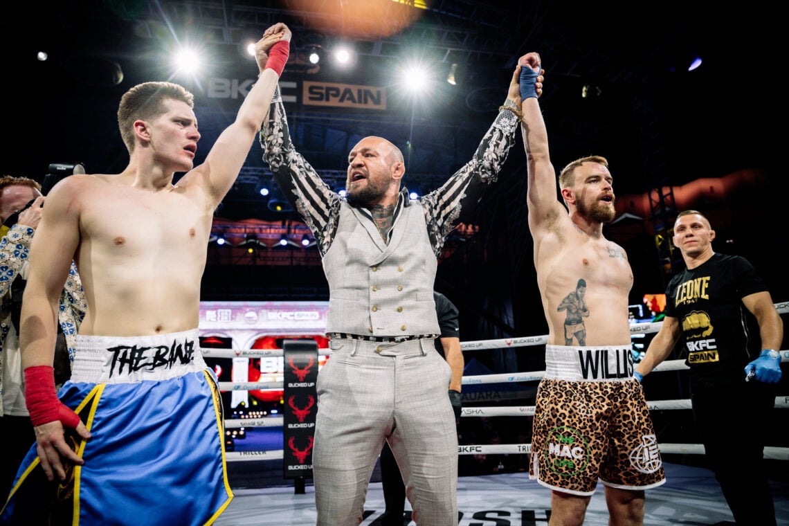 Conor McGregor raises the arms of Ben Davis and Oscar Willis after their BKFC fight