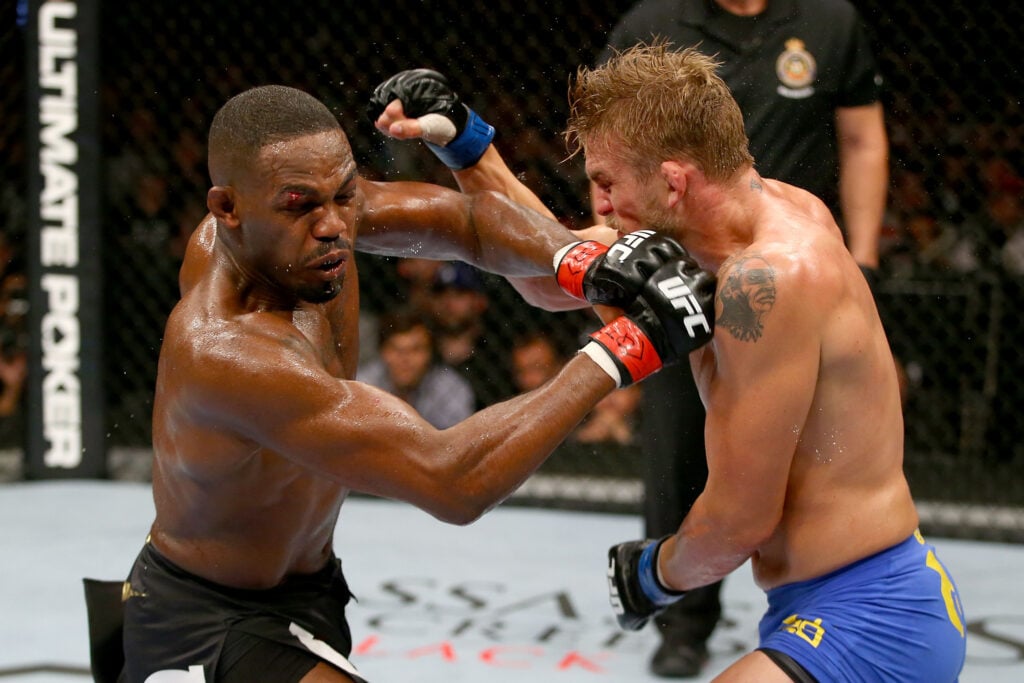 Jon Jones punches Alexander Gustafsson during their title fight at UFC 165