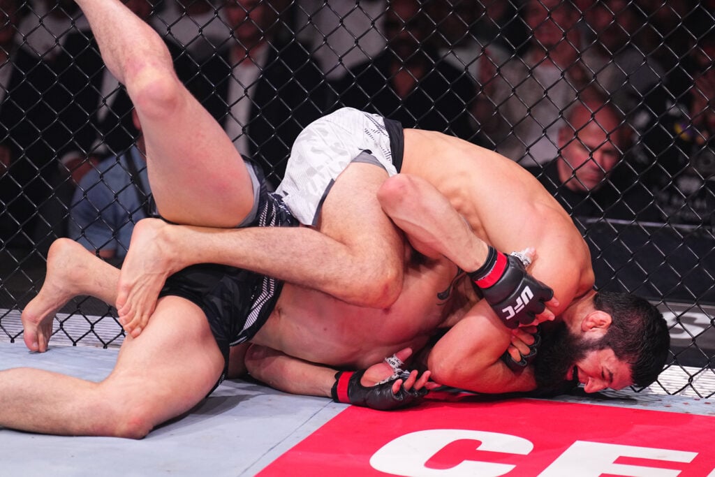 Khamzat Chimaev locks in a face crank to submit Robert Whittaker at UFC 308.