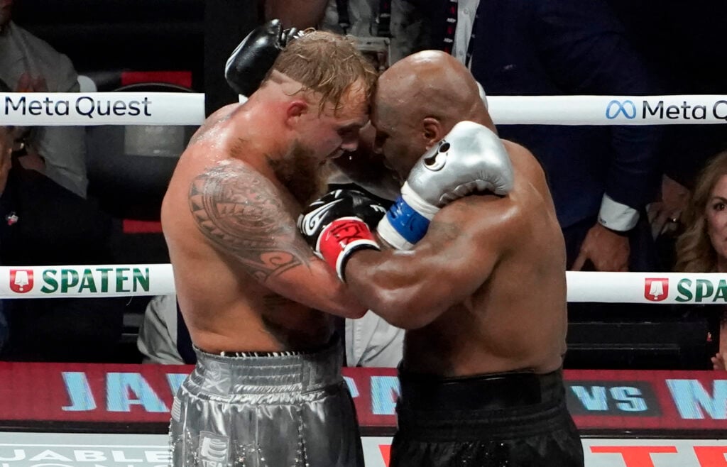 Jake Paul and Mike Tyson embrace in the ring