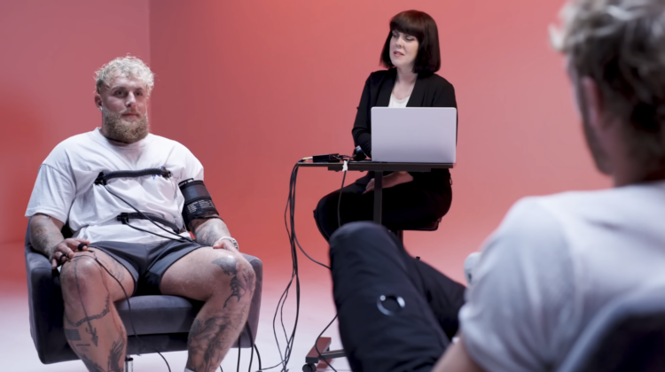 Jake Paul undergoes a lie detector test from his brother Logan (whose back is pictured)