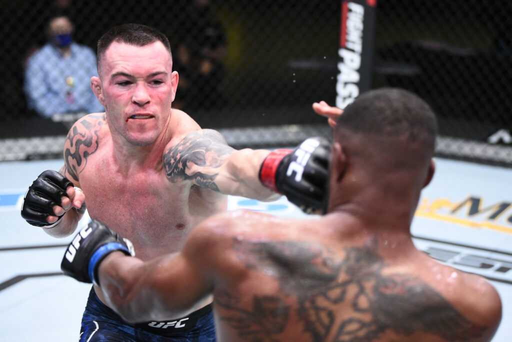 Colby Covington punches Tyron Woodley during their UFC Fight Night main event at the Apex.